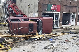 A car lies knocked over on its side after a tornado tore through Sulphur, Okla., Sunday, April 28, 2024. (AP Photo/Ken Miller)
